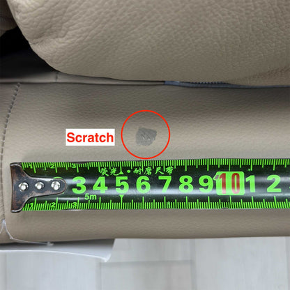 Scratch on the back panel of the G Plan Avon taupe leather sofa circled, tape measure for scale