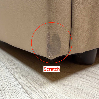 Close-up of a scratch on the bottom corner of the G Plan Avon taupe leather sofa near the foot