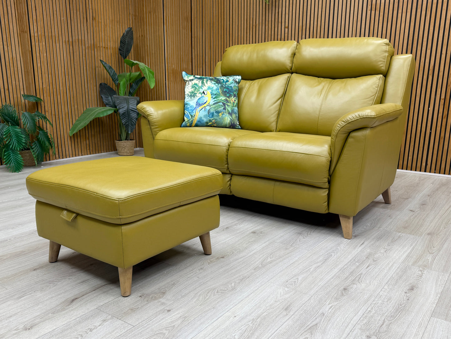 Side profile of the 'Sienna' sofa, illustrating the high backrest and padded arms.