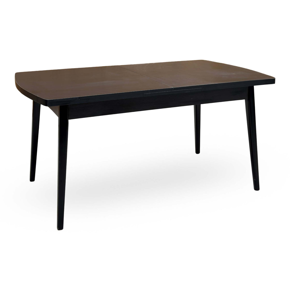 Magda black solid oak large extending dining table unextended, angled view showing the rounded corners