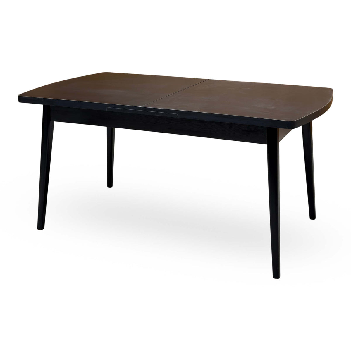 Magda black oak dining table unextended from the right side, showing the centre join in the top