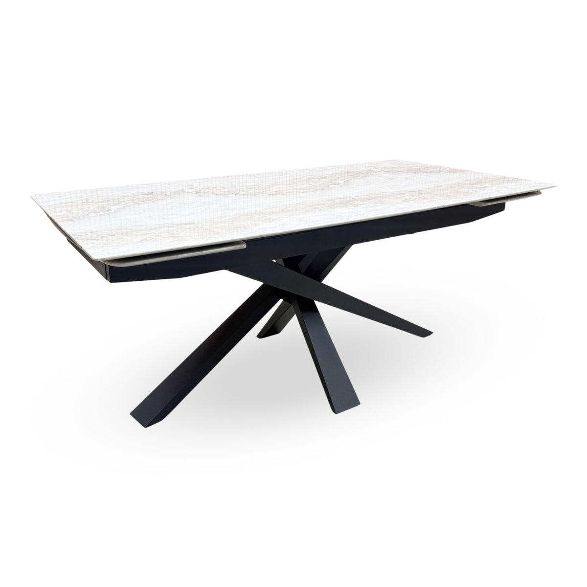 Germain real marble top large extending dining table closed, angled view of the white marble and black star base