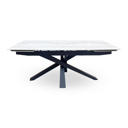 Front view of the Germain real marble top large extending dining table closed on its black metal star base