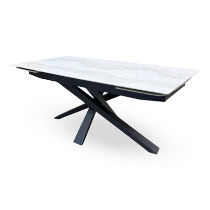 Side angle of the Germain real marble top extending dining table closed, showing the leaf runners under the top