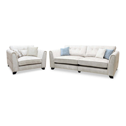 Mariah ivory velvet 4 seater split frame sofa and snuggler chair, angled view with blue patterned cushions