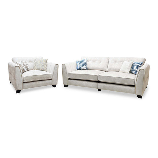 Mariah ivory velvet 4 seater split frame sofa and snuggler chair, angled view with blue patterned cushions