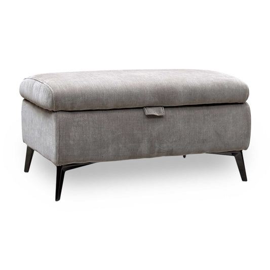 Ezra nutmeg linen fabric storage footstool, angled view with a lid pull tab and black tapered metal legs
