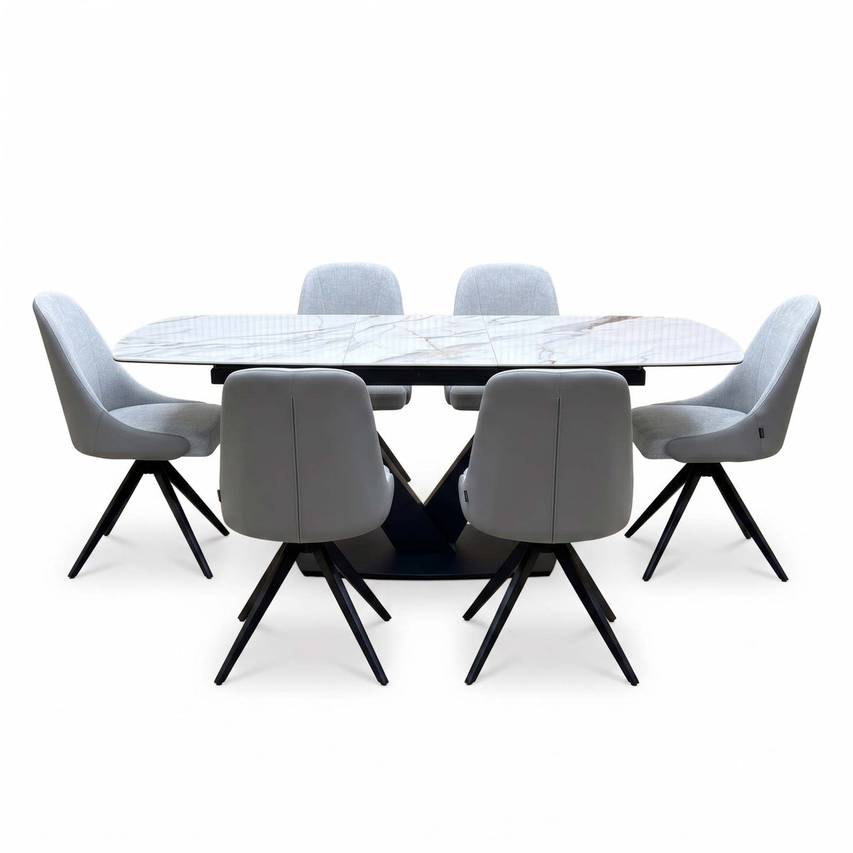 Jose dining set from the far side, stone grey swivel chair backs and the black V pedestal of the marble effect table