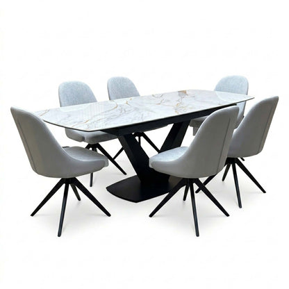 Jose white marble effect extending table and six stone grey faux leather swivel chairs with black splayed legs