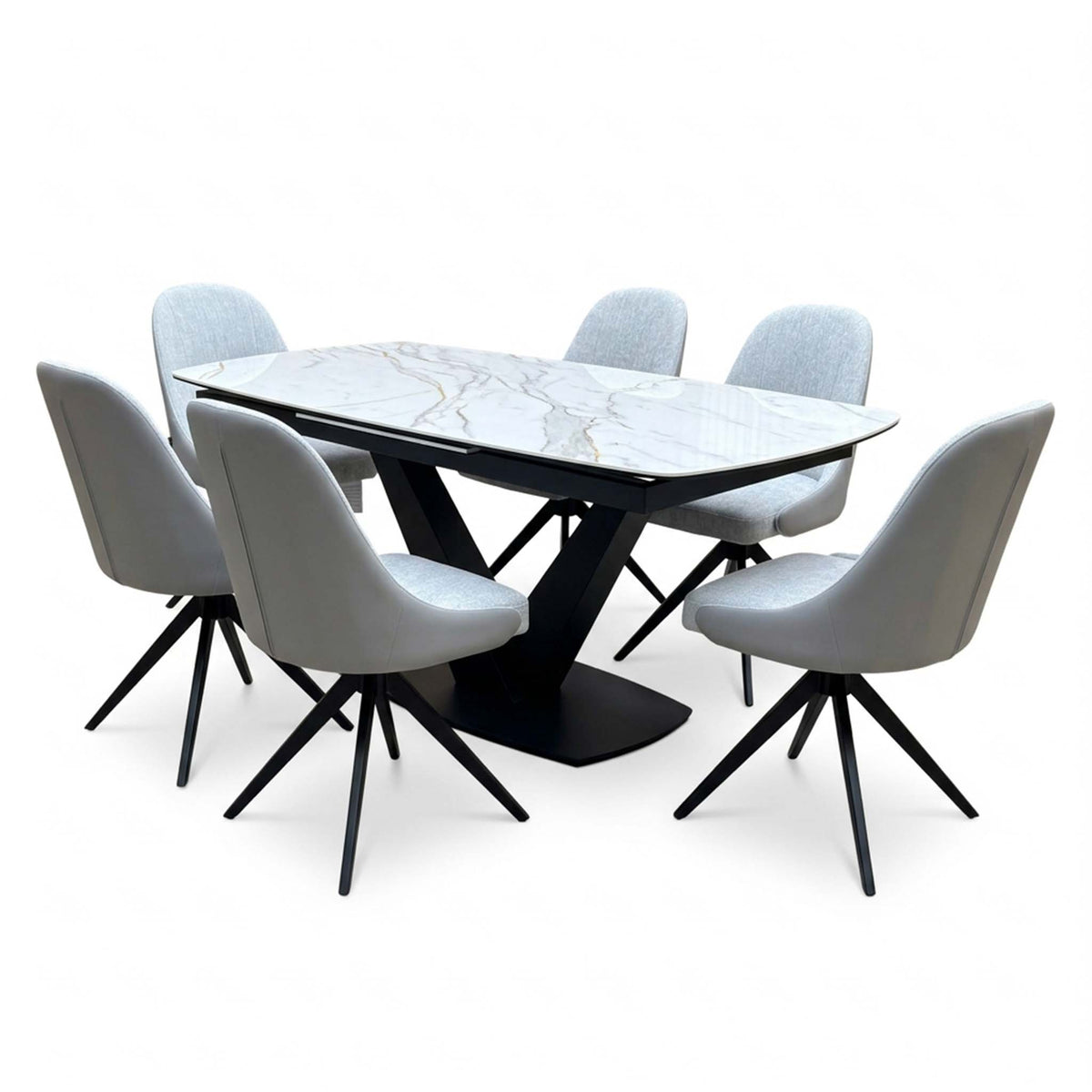 Jose white marble effect table with six stone grey faux leather swivel chairs, close angled view showing the black legs