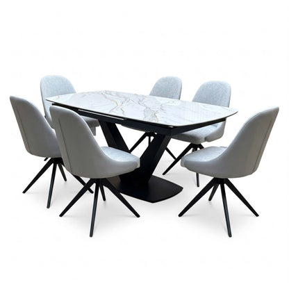 Jose white marble effect table with six stone grey faux leather swivel chairs, close angled view showing the black legs