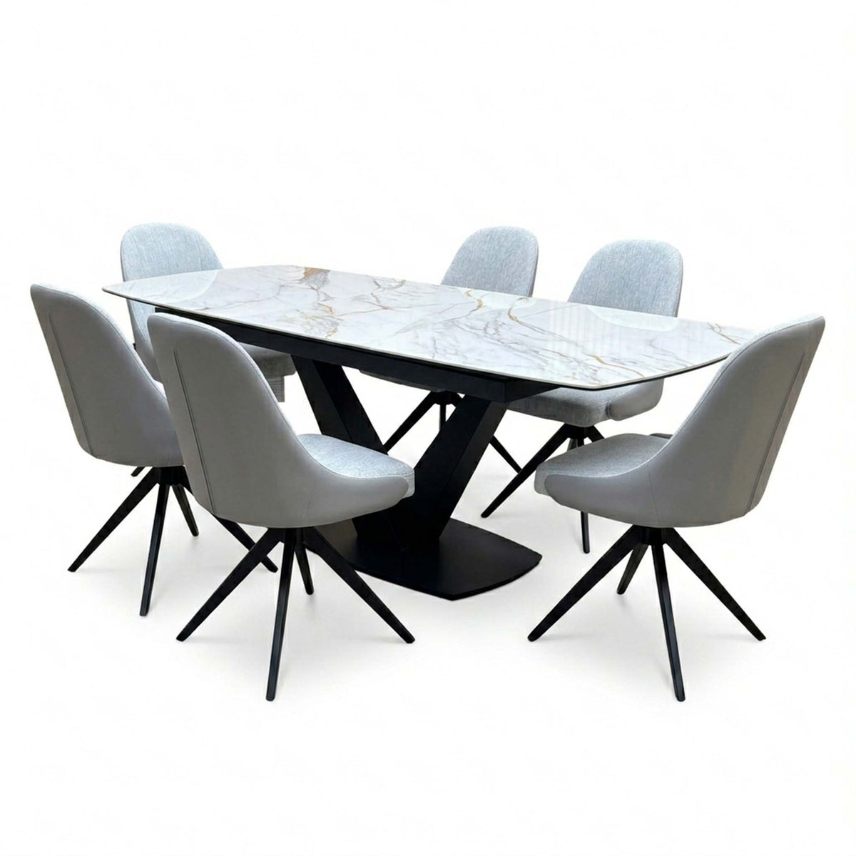 Jose marble effect dining table and six stone grey swivel chairs, angled view showing the gold veined ceramic top