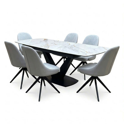 Jose marble effect dining table and six stone grey swivel chairs, angled view showing the gold veined ceramic top
