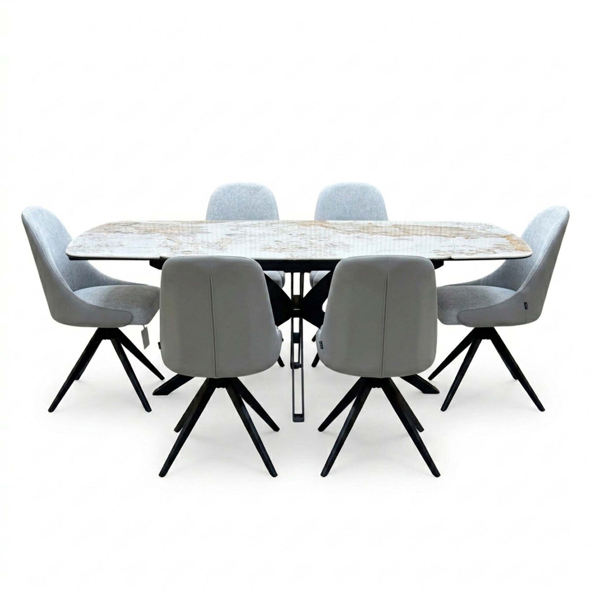 Front view of the Jose Calcatta marble dining table set with the draw leaves extended and six stone grey chairs
