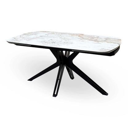 Jose Calcatta marble 160cm dining table, closed, angled view from the left showing the black metal star base