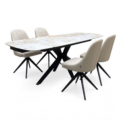Jose Calcatta marble 160cm extending dining table with 4 beige fabric swivel chairs, angled view from the right