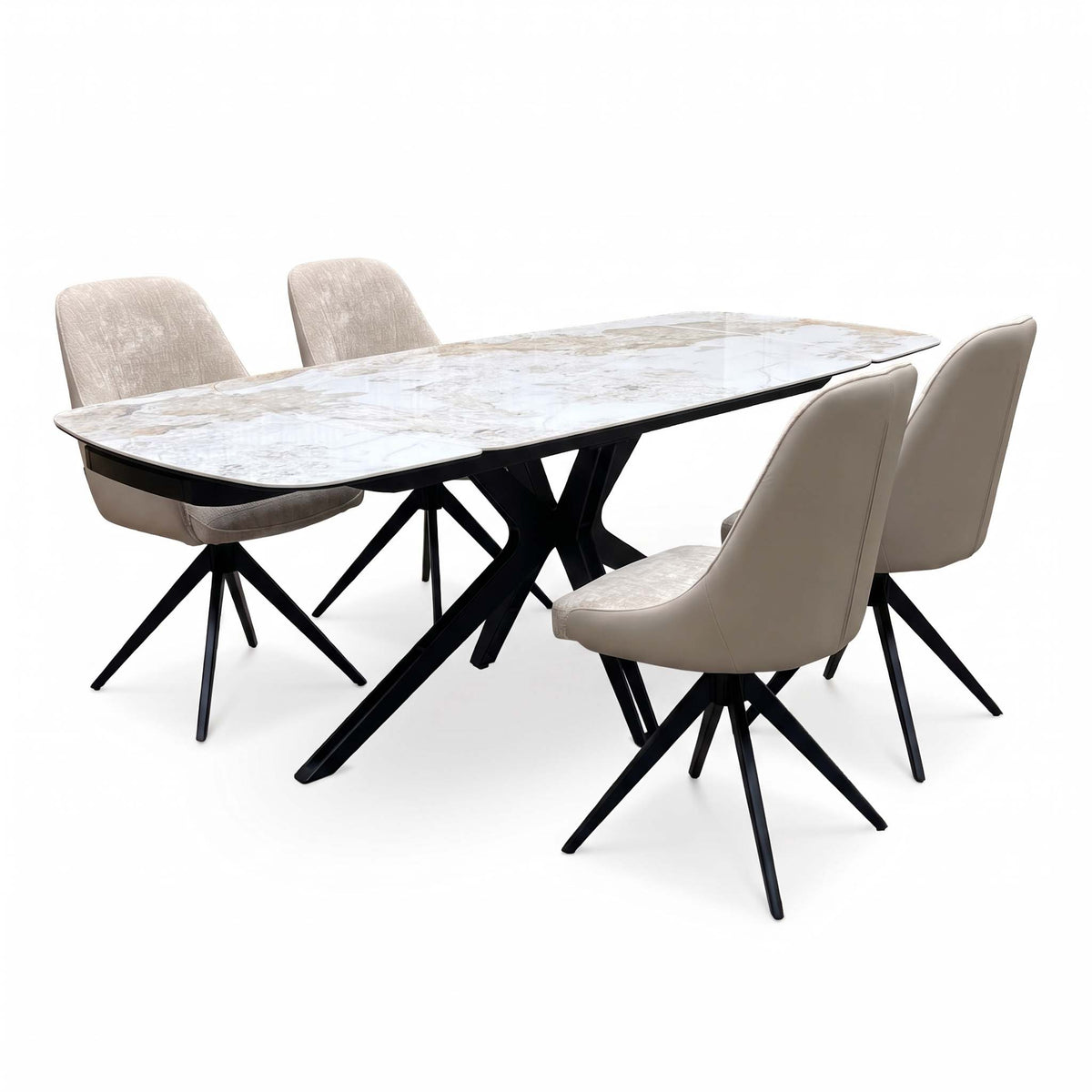 Jose Calcatta marble extending dining table with two cream arm chairs and two armless chairs, angled view