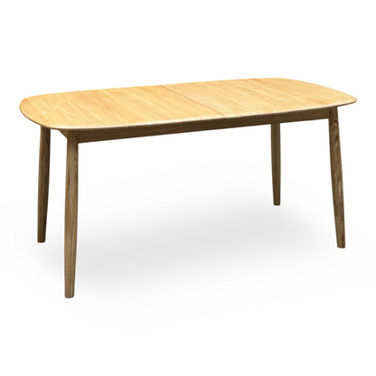 Stockholm light oak large extending dining table, closed, angled view showing the rounded corners