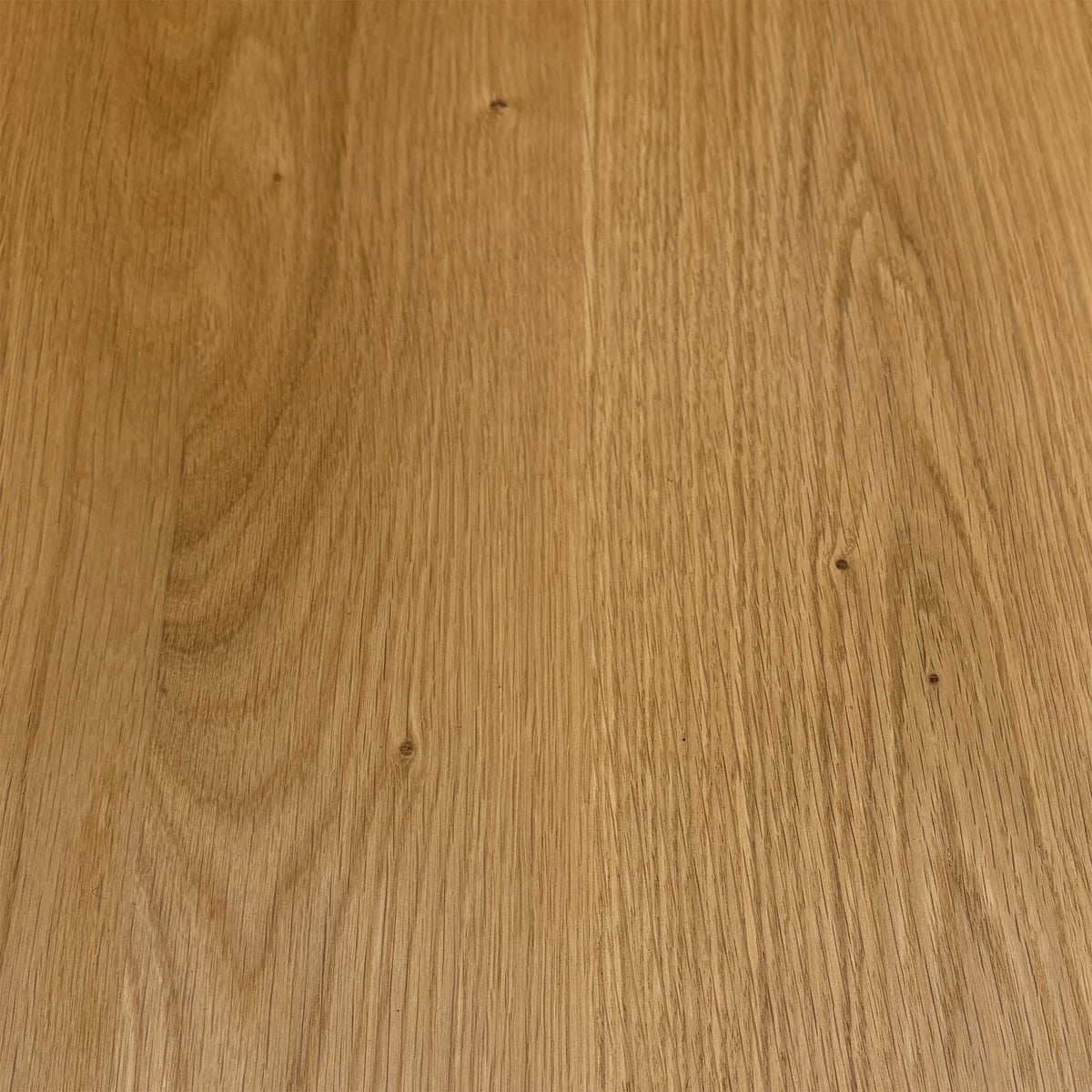 Close-up of the light oak grain used on the Stockholm solid oak dining table top