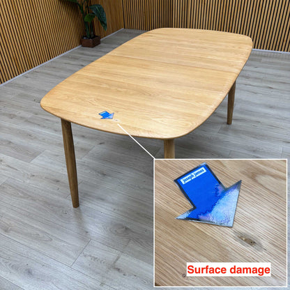 Stockholm light oak dining table top with a small surface mark arrowed near the edge, close-up inset