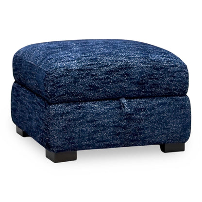 Nova dark denim blue woven fabric storage footstool, angled from the right with dark block feet