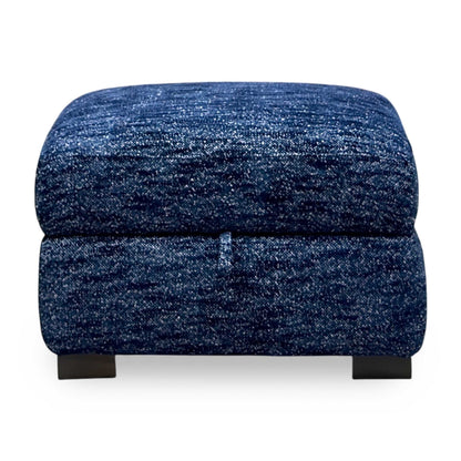 Front view of the Nova dark denim blue woven fabric storage footstool with fabric pull tab