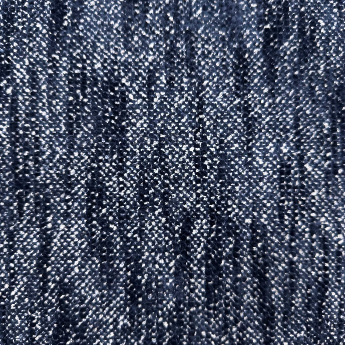Close-up of the dark denim blue woven fabric used on the Nova storage footstool