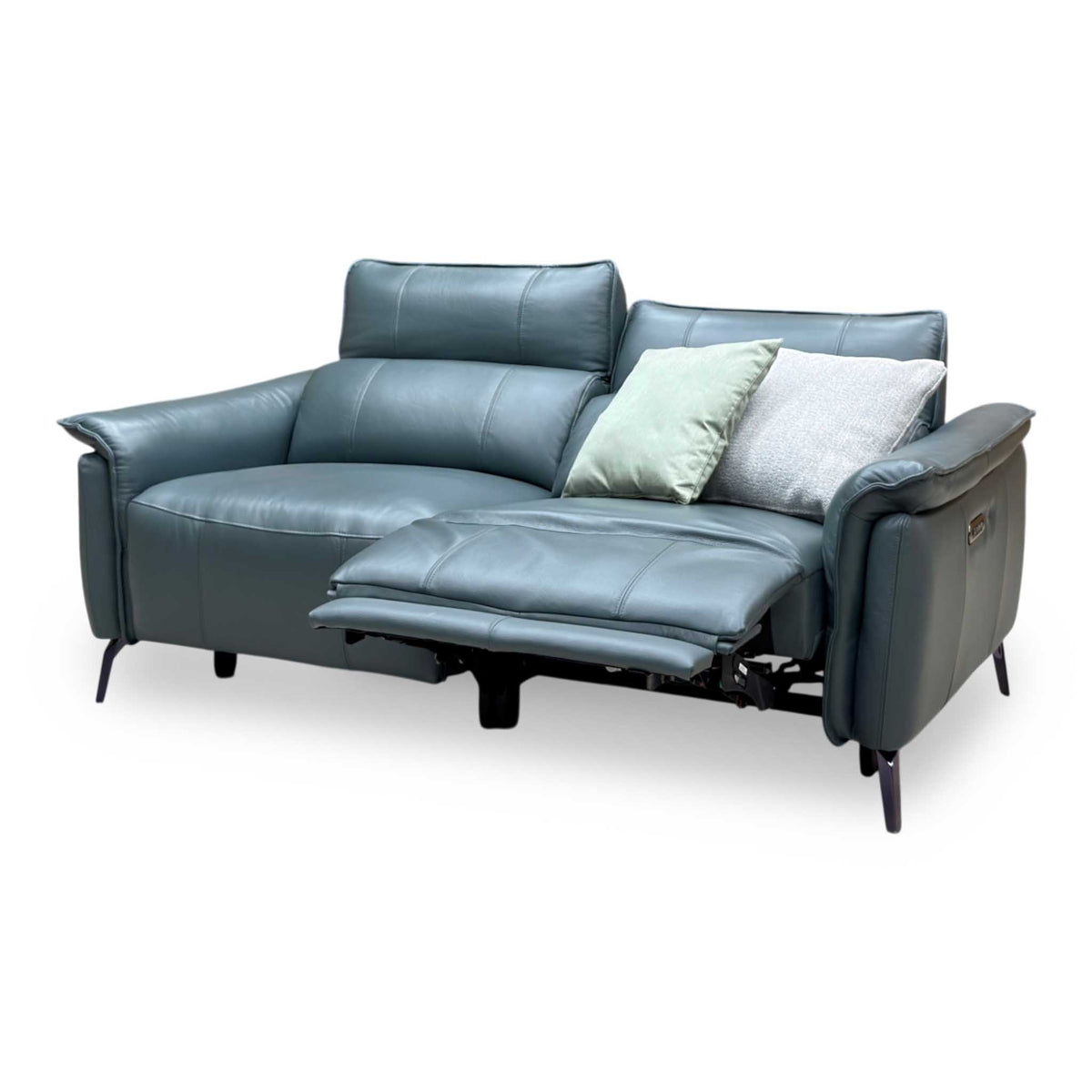 Jude Oslo peacock green leather sofa from the right with the left seat footrest raised