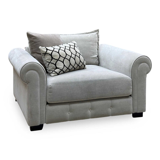 Sumptuous linen fabric snuggler chair, angled view with scroll arms and a patterned cushion