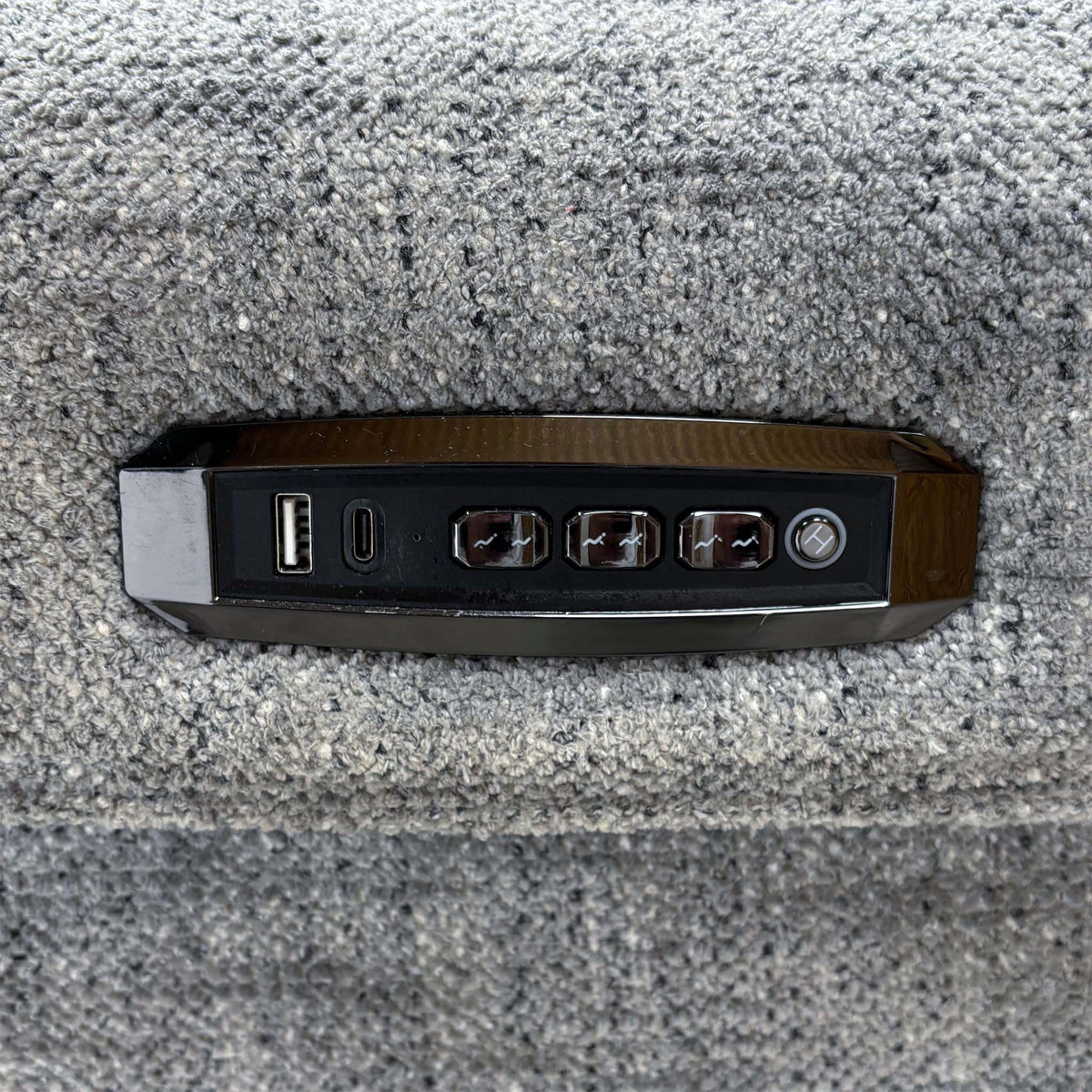 Close-up of the Hollywood sofa side panel with USB, USB-C and power recline buttons set into the grey fabric
