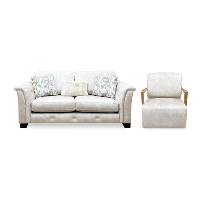 Front view of the Aura Kenzo cream velvet 3 seater sofa and the swivel chair with wooden arms