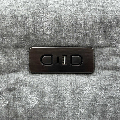 Close-up of the power recline buttons and USB ports on the Darren light grey fabric sofa