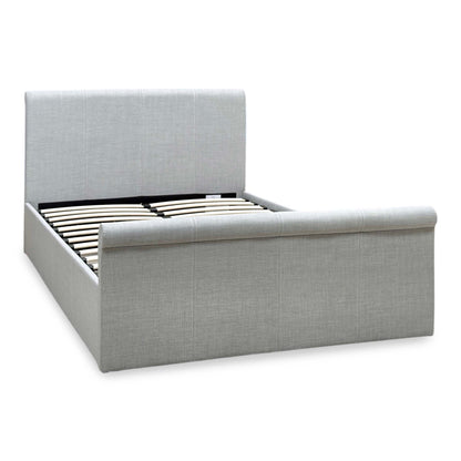 Stanley grey fabric small double ottoman bed, angled view from the left showing the padded headboard