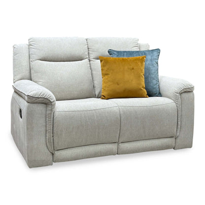 Miro natural fabric 2 seater manual recliner sofa, angled from the left with ochre and blue cushions