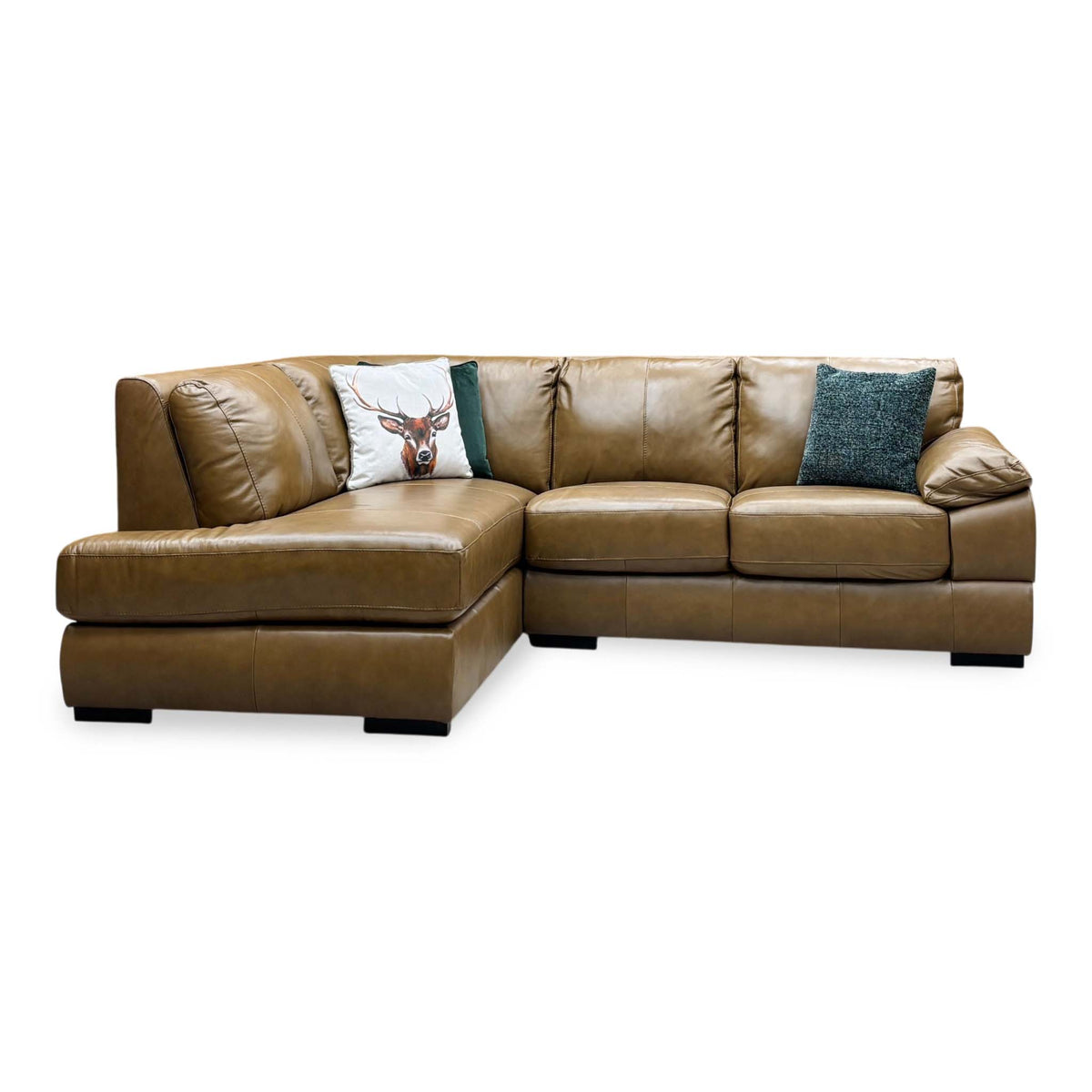 Front view of the Marlow tan brown leather corner sofa with the chaise on the left and a padded arm on the right