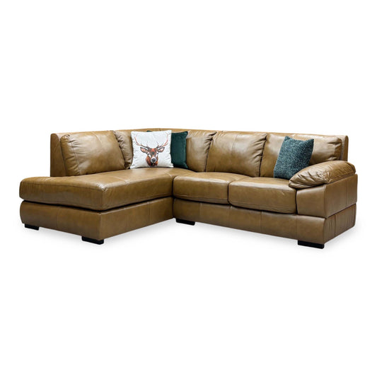 Marlow tan brown leather left hand corner chaise sofa, angled view with stag and teal scatter cushions