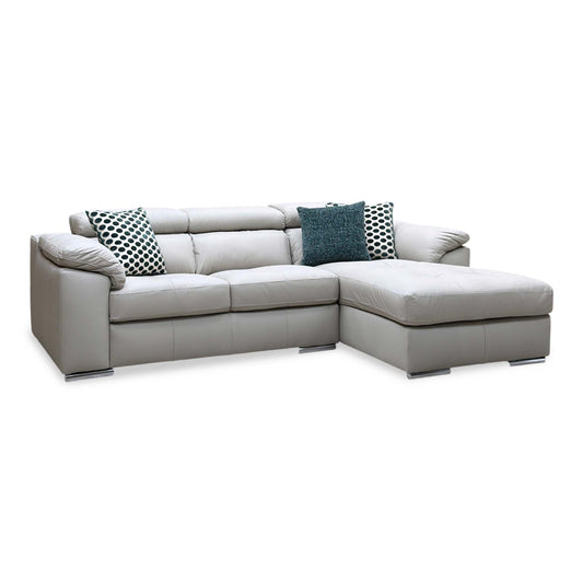 Brady grey leather 3 seater right hand chaise sofa, angled view with teal and polka dot scatter cushions