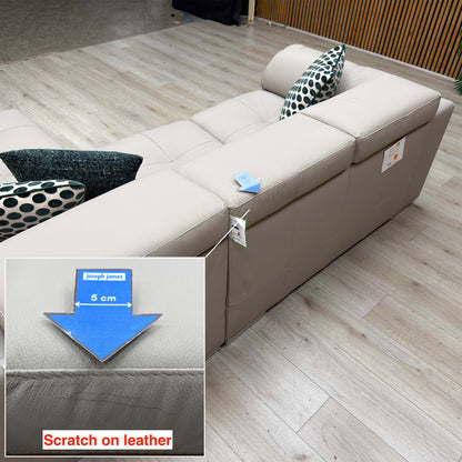 Brady grey leather chaise sofa seat edge with a scratch on the leather marked by a 5cm arrow, labels still attached