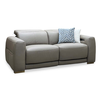 Edison taupe leather 3 seater sofa upright, angled view with blue geometric scatter cushions