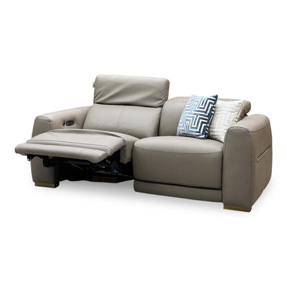Edison taupe leather power recliner sofa with the left seat reclined and headrest raised, angled from the left
