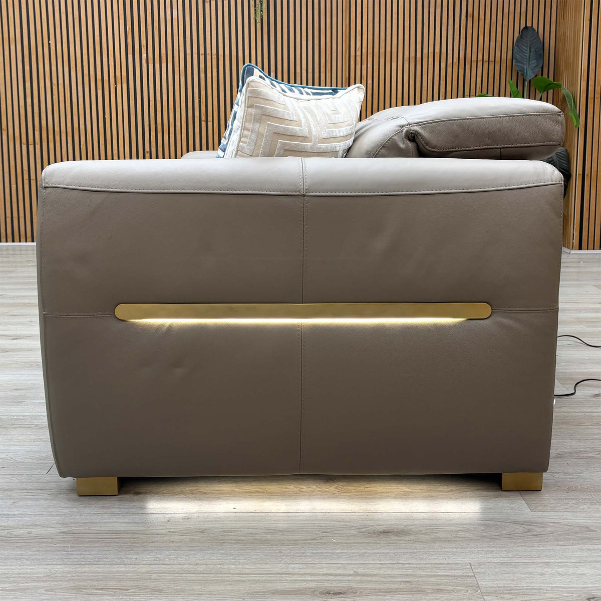 Back view of the Edison taupe leather sofa showing the LED light strip lit across the back panel
