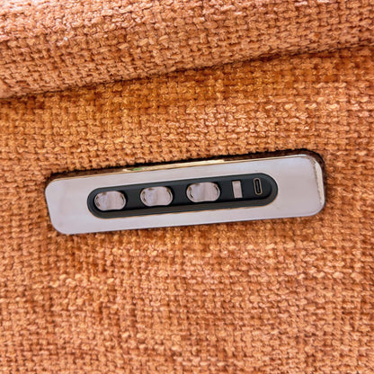 Close-up of the power recline, headrest and lumbar buttons with USB-C port on the Nicoletti Vito orange sofa