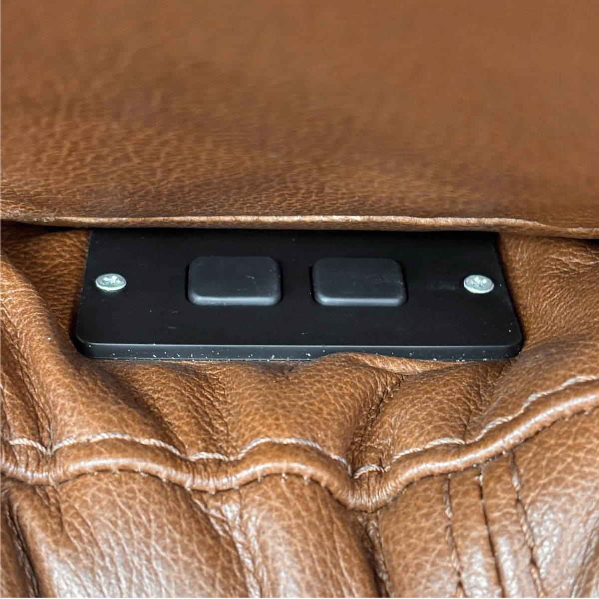 Close-up of the two-button power recline control panel on the arm of the Marinelli Viali bark brown leather sofa