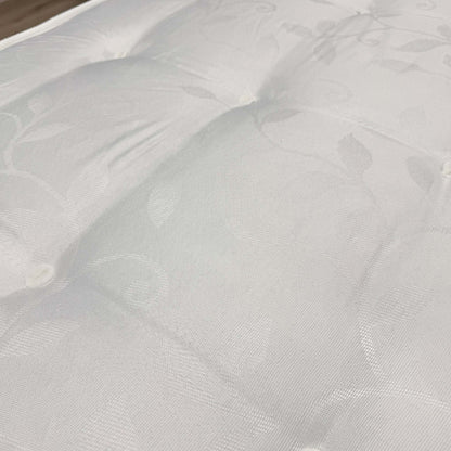 Close-up of the quilted damask cover on the Unwind mattress supplied with the Gus guest bed
