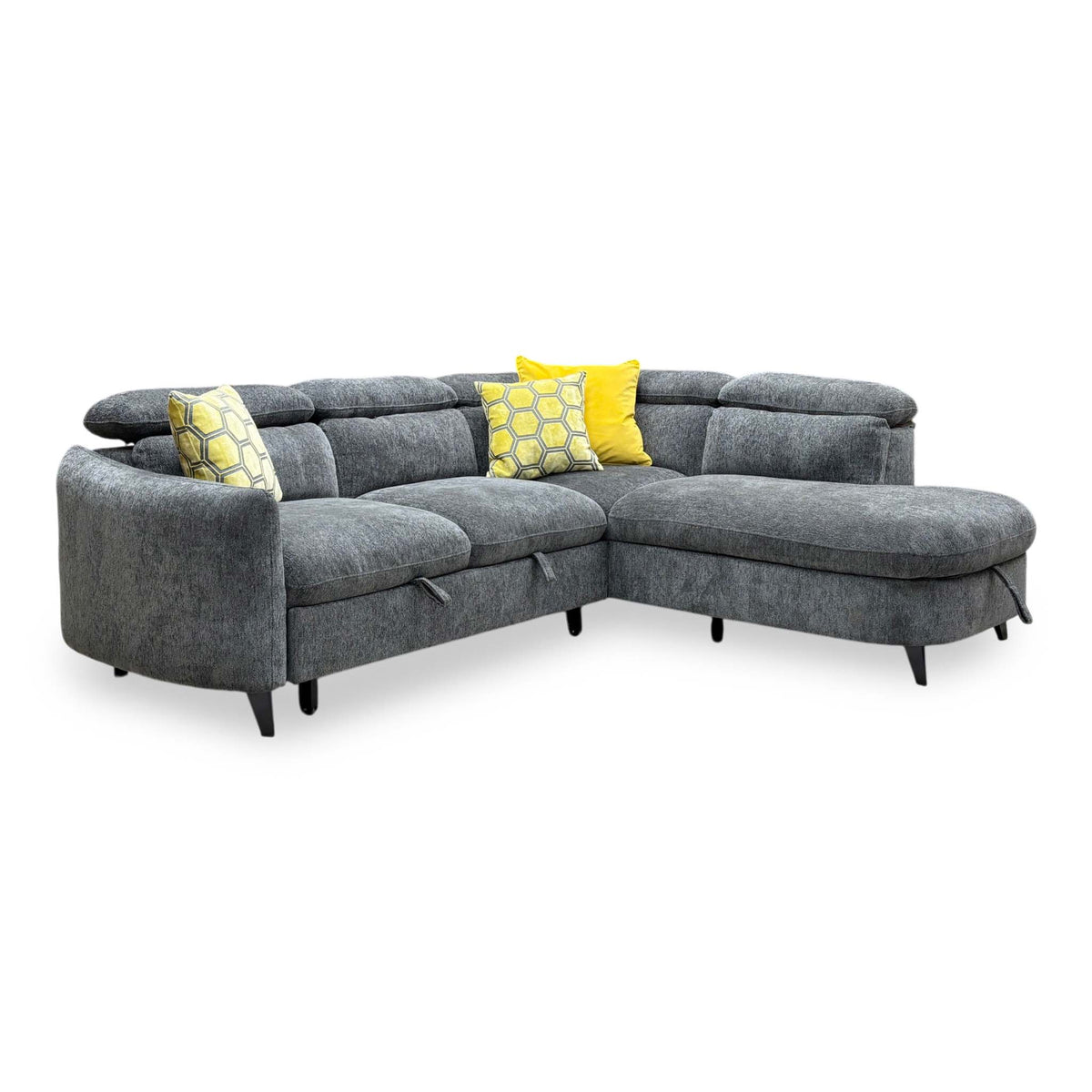 Angled view of the Snooze charcoal grey chenille corner sofa bed with adjustable headrests and yellow scatter cushions