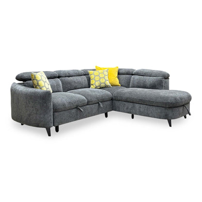 Angled view of the Snooze charcoal grey chenille corner sofa bed with adjustable headrests and yellow scatter cushions
