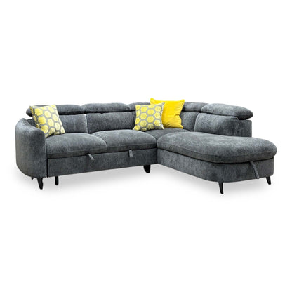 Snooze charcoal grey chenille corner sofa bed seen from the left, chaise end to the right with black tapered legs