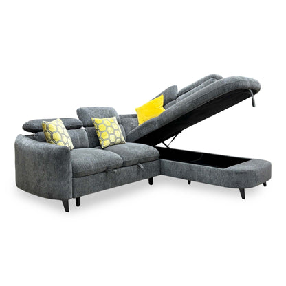 Snooze charcoal grey chenille corner sofa bed with the chaise end lifted to show the storage space, angled view