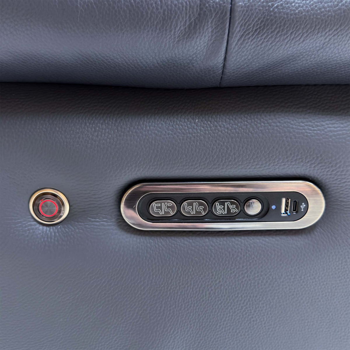 Close-up of the Jude arm control panel with three power buttons, USB port and a round illuminated switch