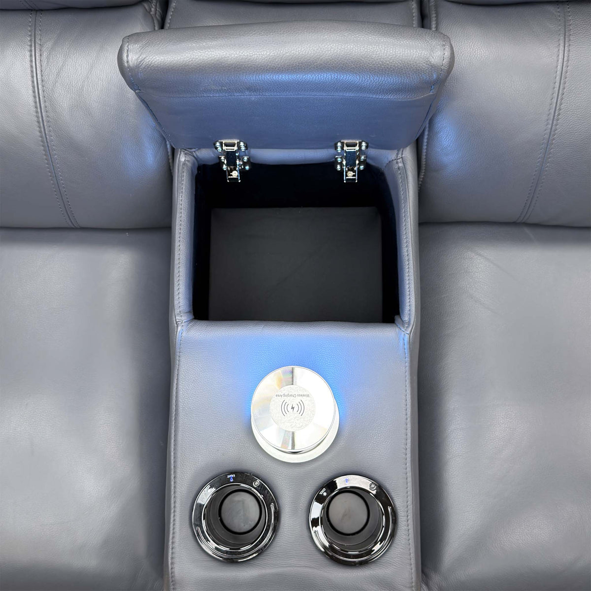 Close-up of the Jude recliner smart console open, with wireless charging tower and two cup holders